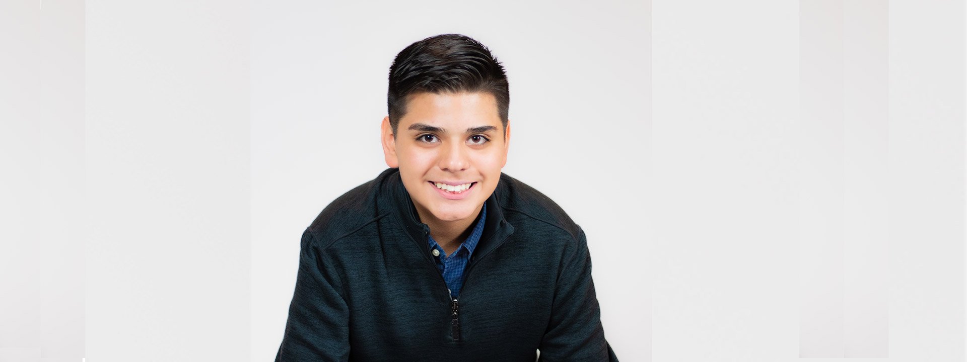 Patient ambassador Landon wearing black shirt and smiling