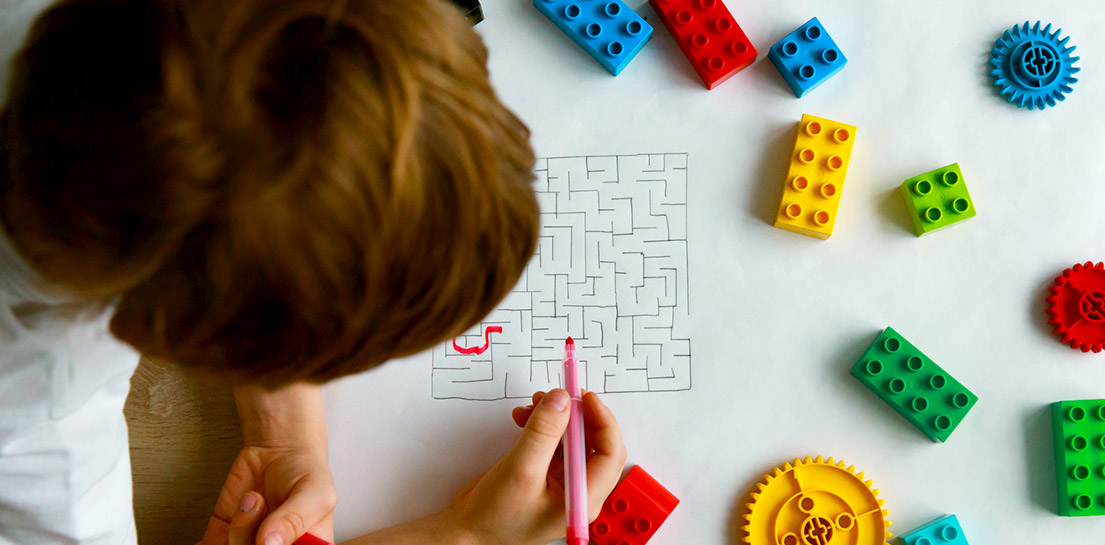Child working on pathway through maze
