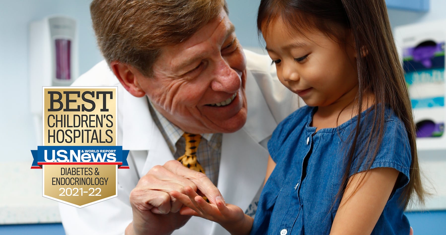 Doctor examines girl's hand. BEST CHILDREN'S HOSPITALS U.S. News & World Report DIABETES & ENDOCRINOLOGY 2021-22 award