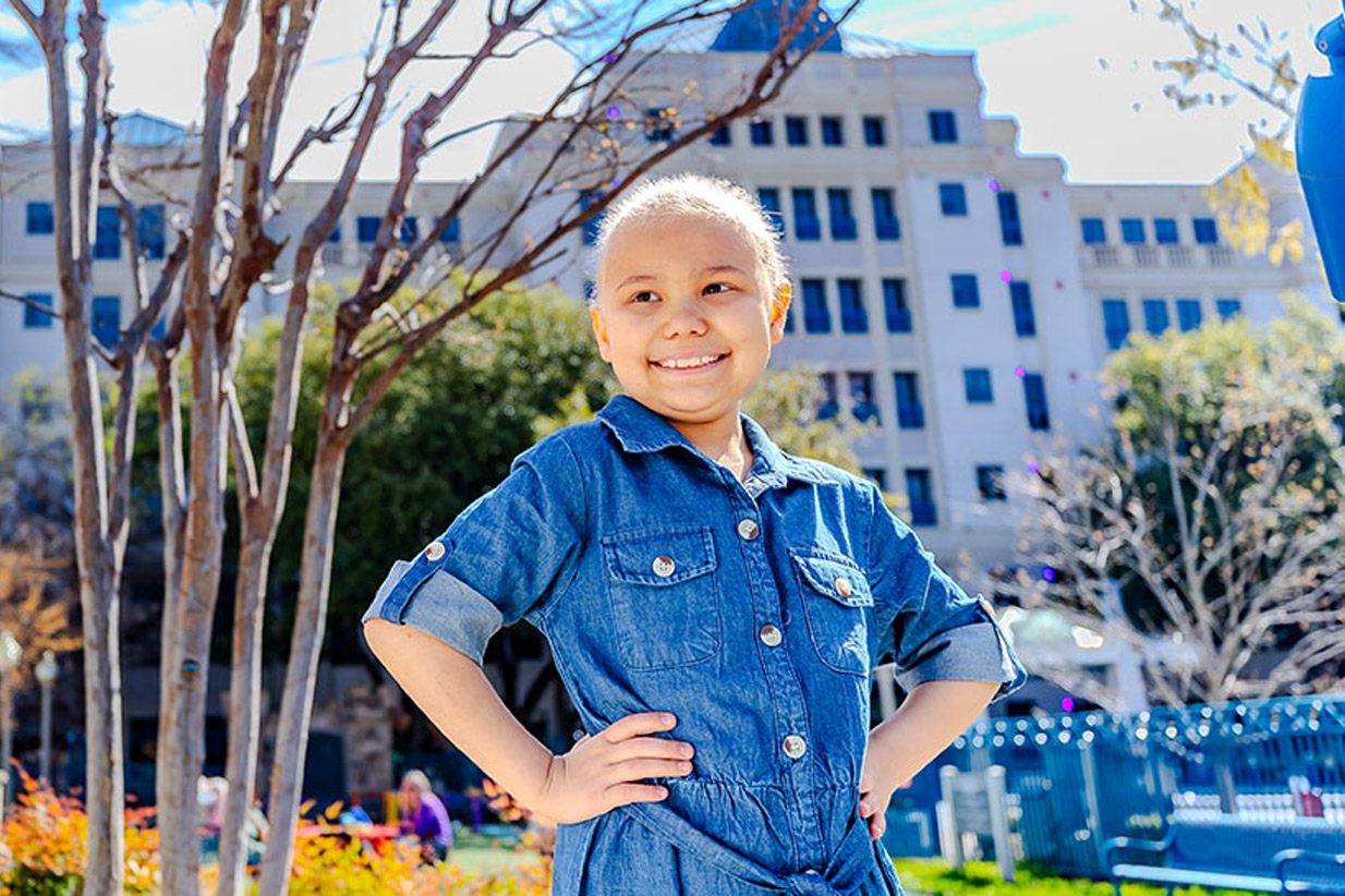 Girl in blue standing in front of Cooks Medical Center