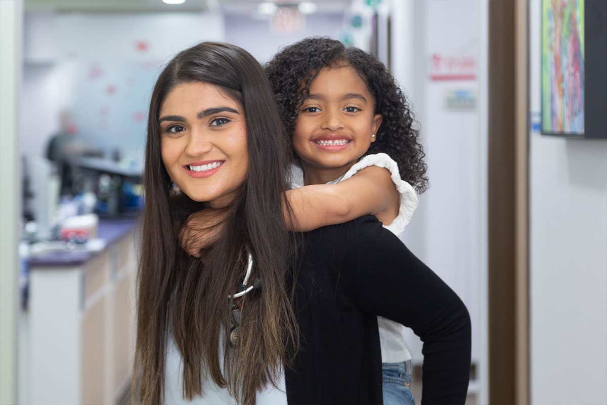 Dr. Nasir giving piggyback to girl