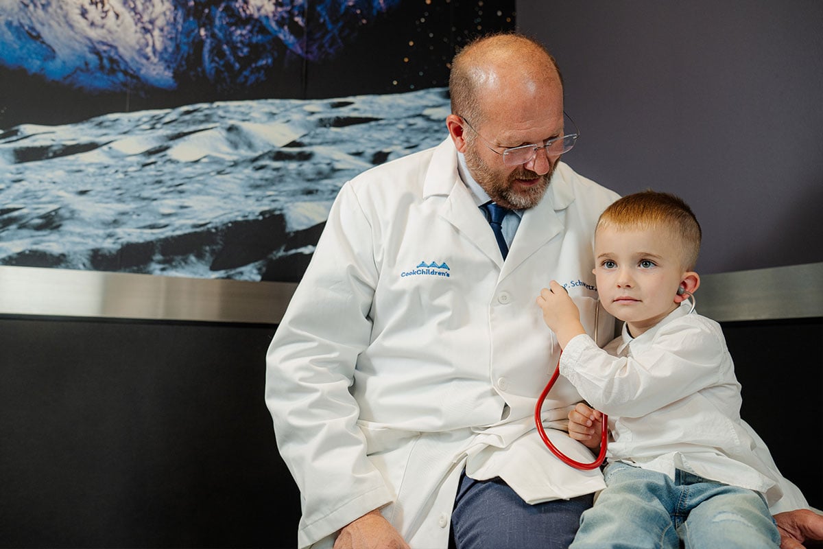 Pediatric physician playing with a patient at a primary care office in Plano