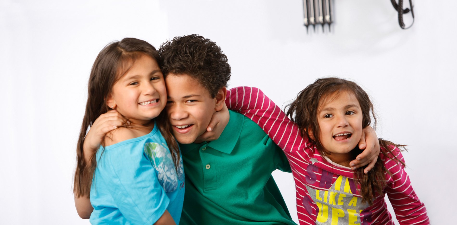 Three smiling kids at the doctor's office