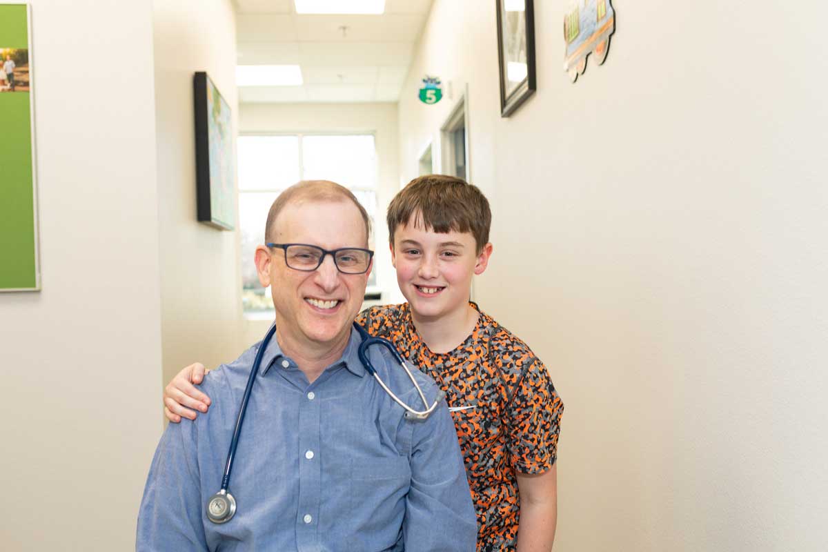 Dr. Seth Kaplan hugged by boy