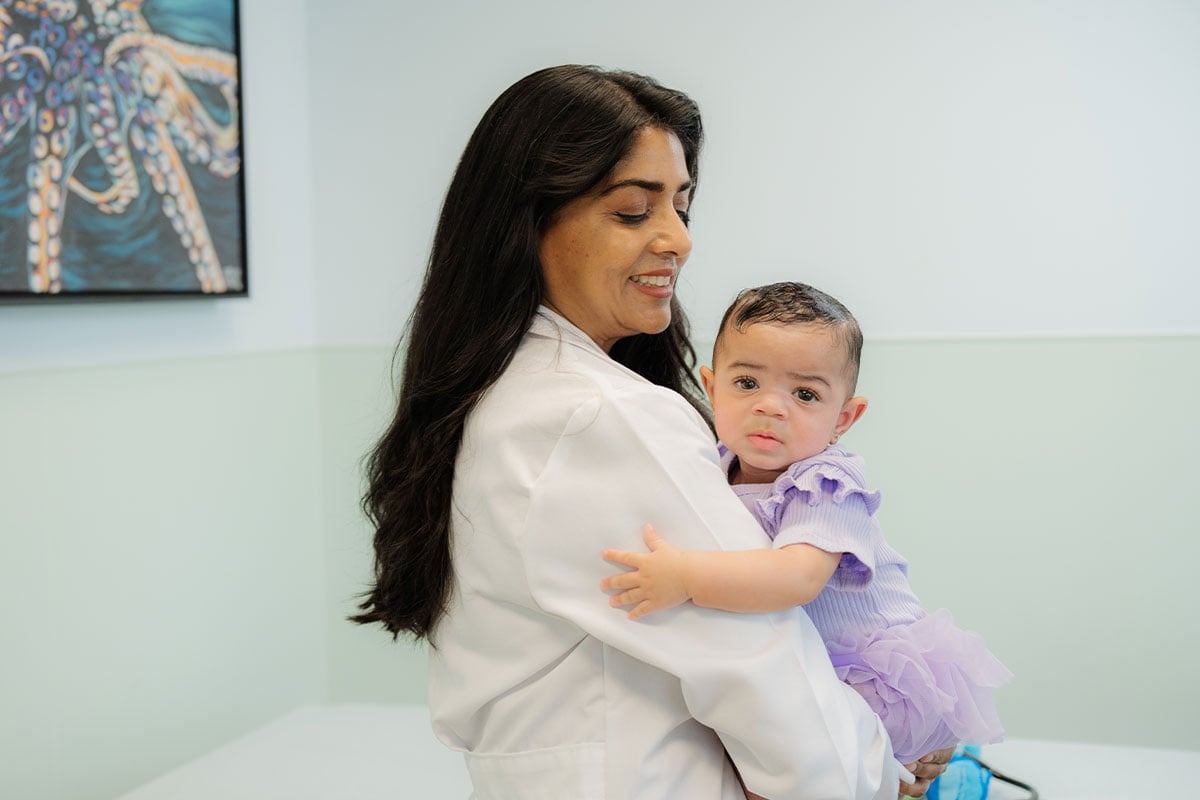 A pediatric physician examining a young baby at a children’s primary care office in Plano, Texas
