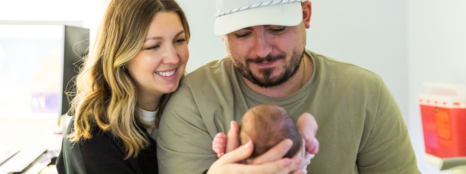 Mom and dad holding NICU baby
