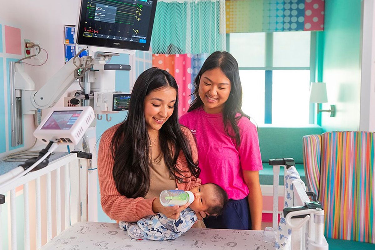 Nurse and family with child in Prosper NICU