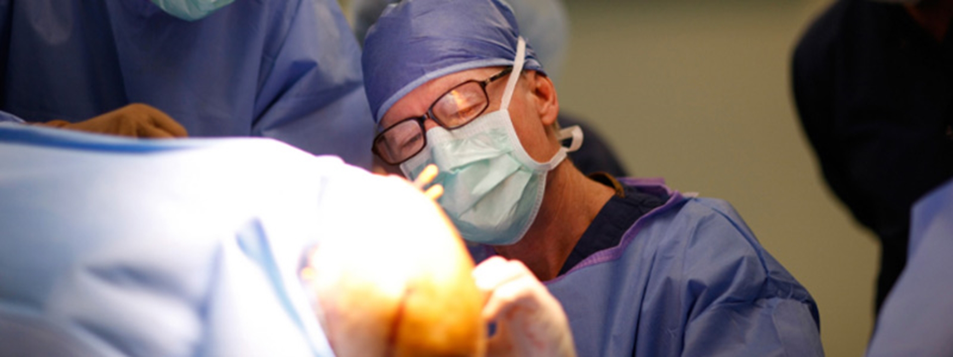 neurosurgeons performing deep brain surgery on patient