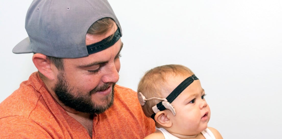 Child getting hearing test with father