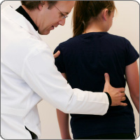 Doctor examining patient's back alignment