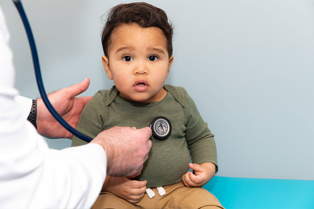 Boy getting examined with stethoscope