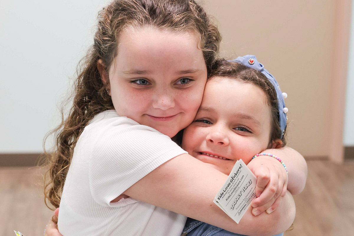 Two girls hugging