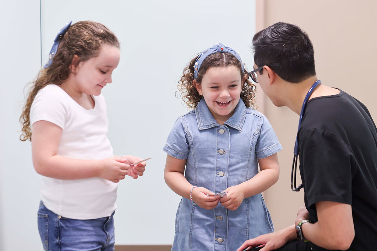 Two girls talking with doctor