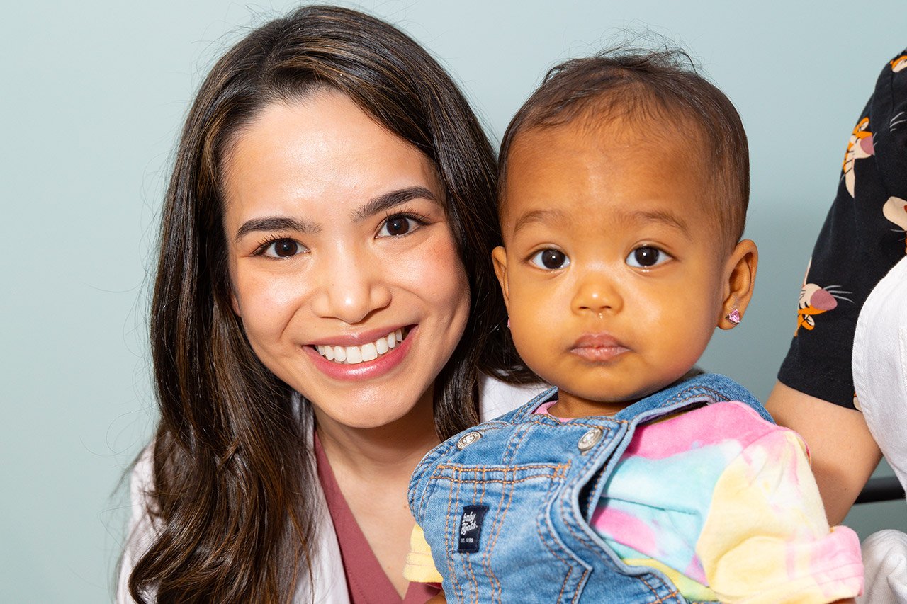 Dr. Courtney Tran caring for young girl
