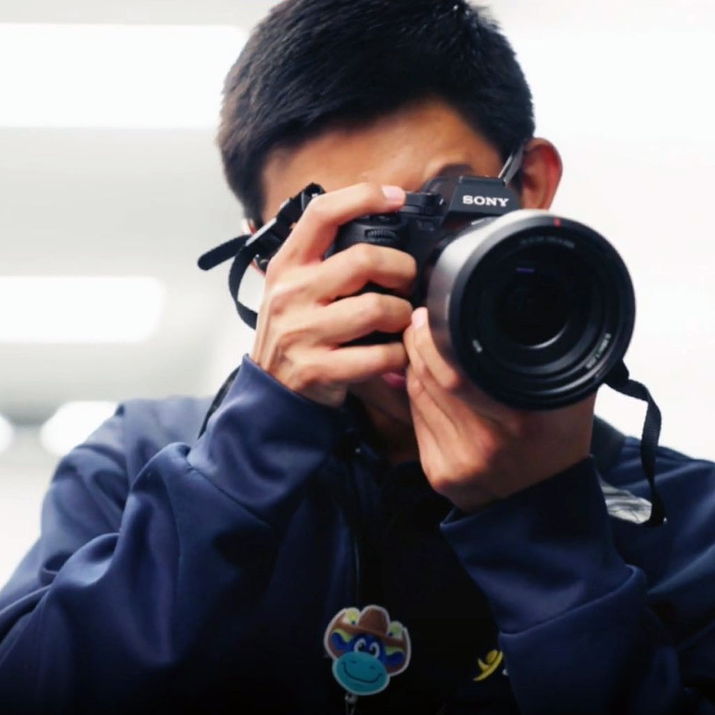 Cook Children’s photographer, Eduardo, looking through camera lens Cook Children’s photographer, Eduardo, looking through camera lens