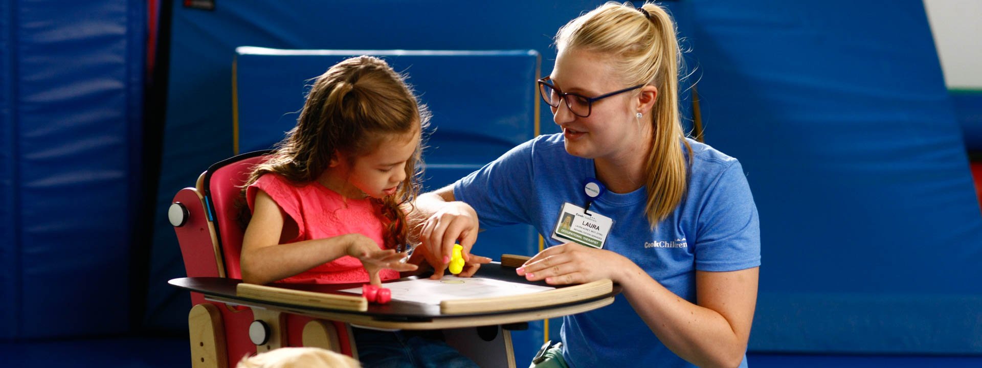 Therapist helping young girl